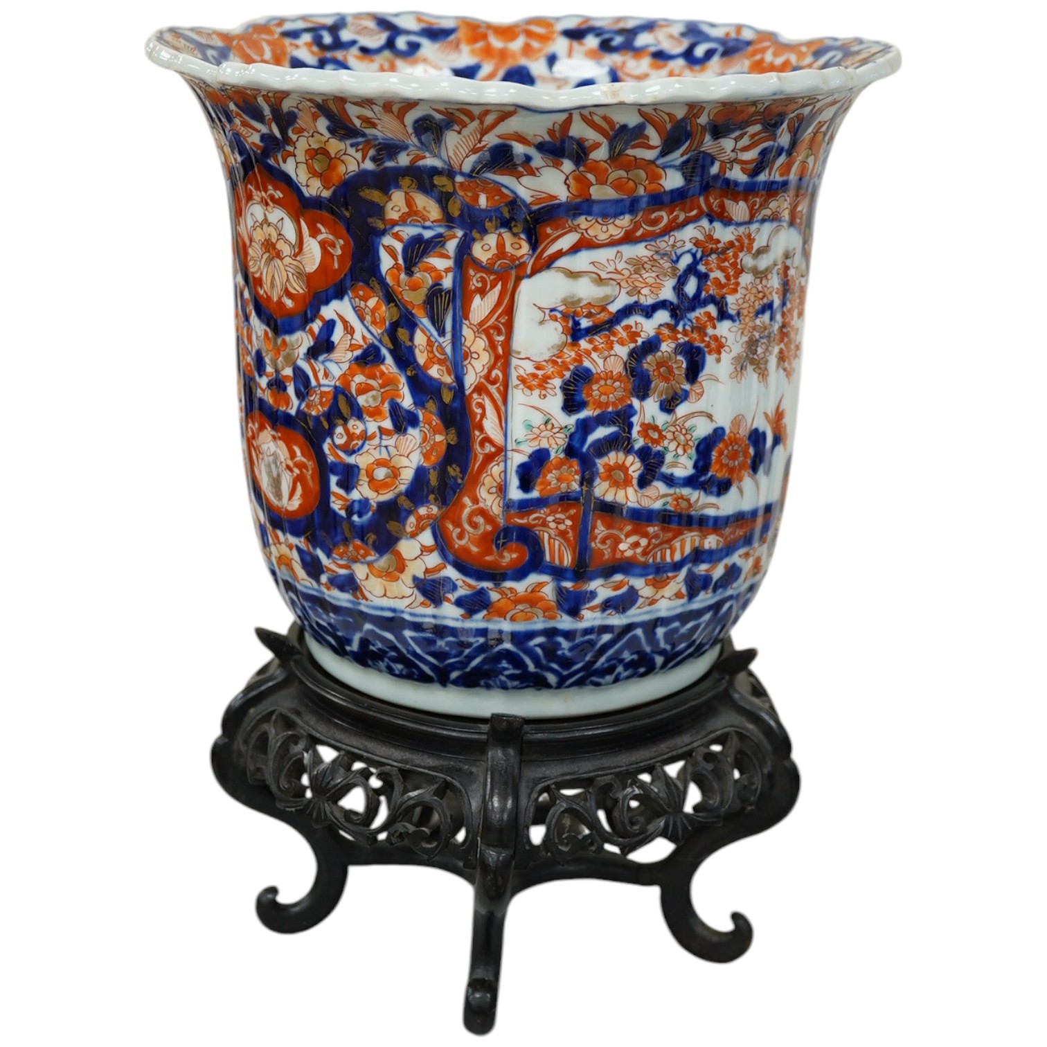 A late 19th century Japanese Imari jardiniere on Chinese hard wood stand, overall 33cm high. Condition - good, stand with some losses